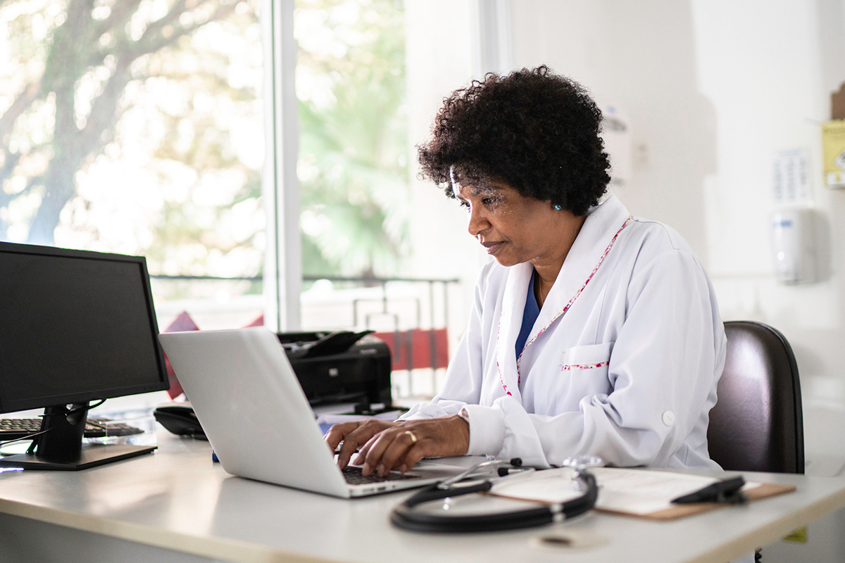 Female black doctor sitting in office